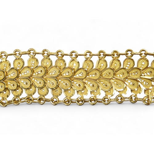 584 - A yellow metal bracelet - of pierced foliate form linked by chain, stamped 21ct, 37.8g.