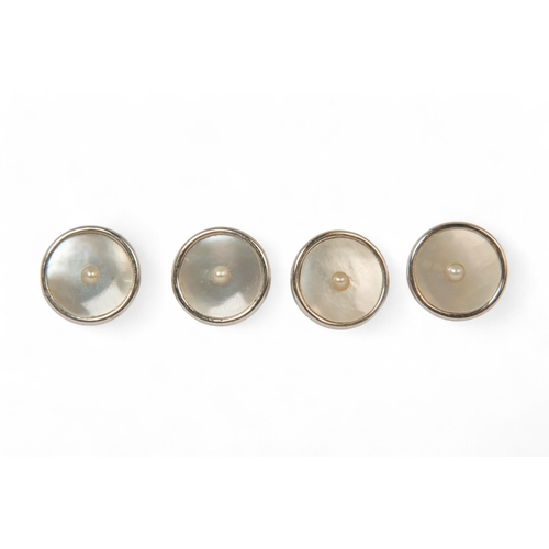 593 - A 9ct white gold pearl and mother-of-pearl stud set - boxed, 11g.