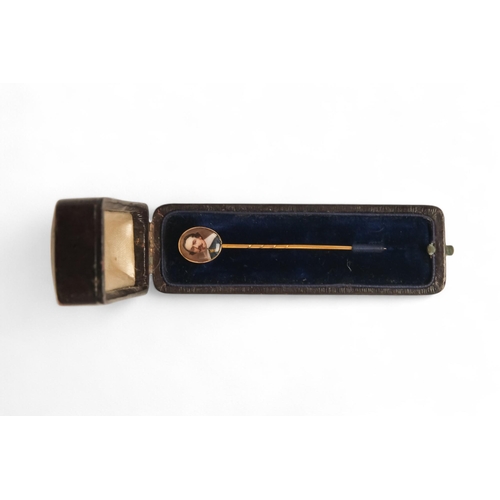 596 - A 9ct gold stick pin - oval painted with a figure of a 17th century gentleman, 1.6g.