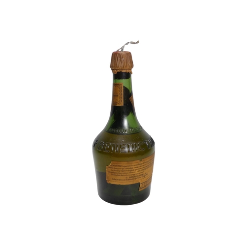 60 - A vintage bottle of Cointreau triple sec - together with a bottle of Benedictine. (2)