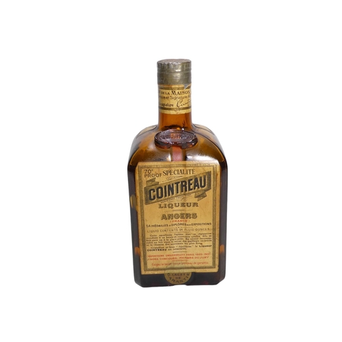 60 - A vintage bottle of Cointreau triple sec - together with a bottle of Benedictine. (2)