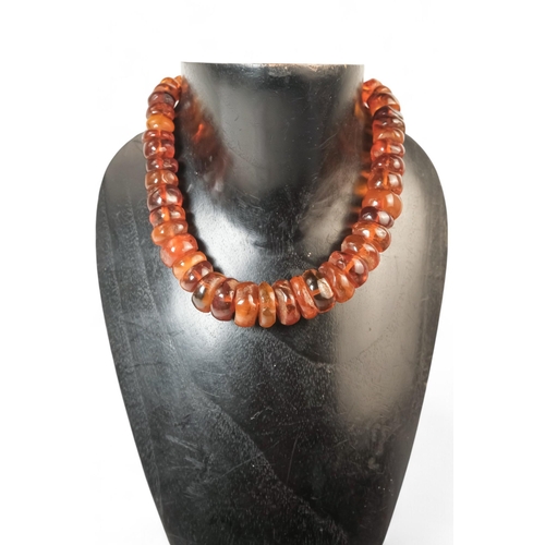 615 - A string of bullet shaped graduated amber beads - length 76cm.