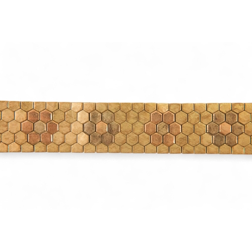 617 - A 9ct gold bracelet - of belt form constructed of articulated hexagons, 43.6g.