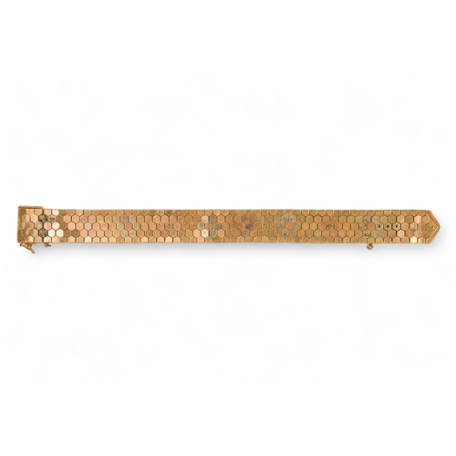 617 - A 9ct gold bracelet - of belt form constructed of articulated hexagons, 43.6g.