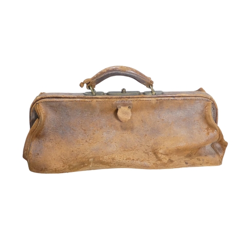 62 - A tan leather Gladstone bag - with a red leather interior, 46cm wide.