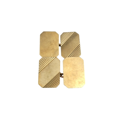 623 - A pair of 9ct gold cuff links - rectangular with canted corners with an engine turned finish, 6.5g.