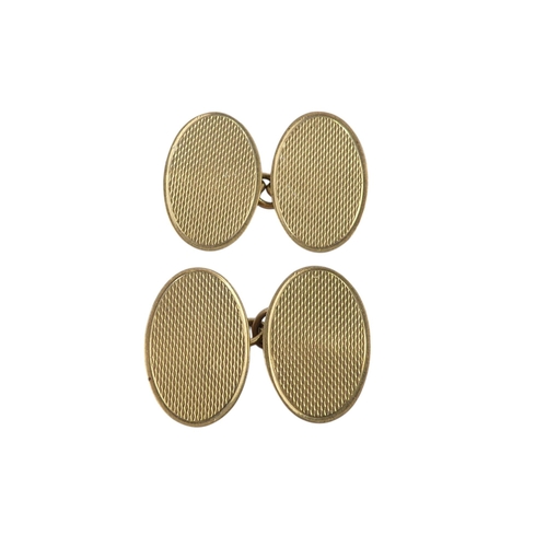 624 - A pair of 9ct gold cuff links - oval with an engine turned finish, 4.1g.