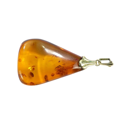 627 - An amber pendant - of polished triangular form, on a 9ct belcher link chain, 11.1g.