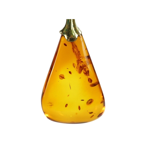 627 - An amber pendant - of polished triangular form, on a 9ct belcher link chain, 11.1g.