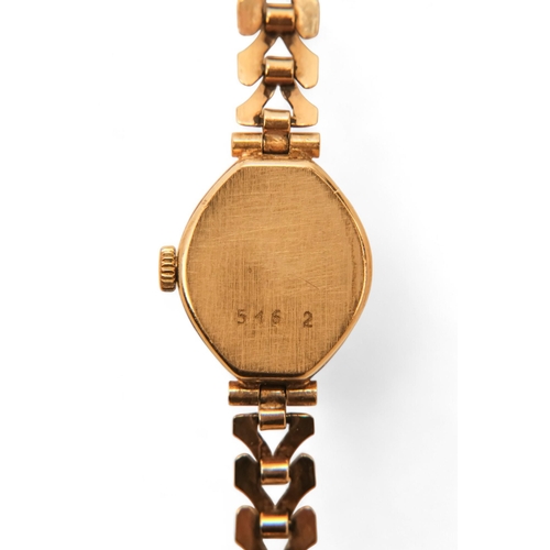 704 - A ladies 9ct gold cocktail watch - oval with a cream dial set out in baton numerals, 10.2g all in, t... 