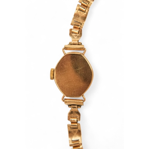 704 - A ladies 9ct gold cocktail watch - oval with a cream dial set out in baton numerals, 10.2g all in, t... 