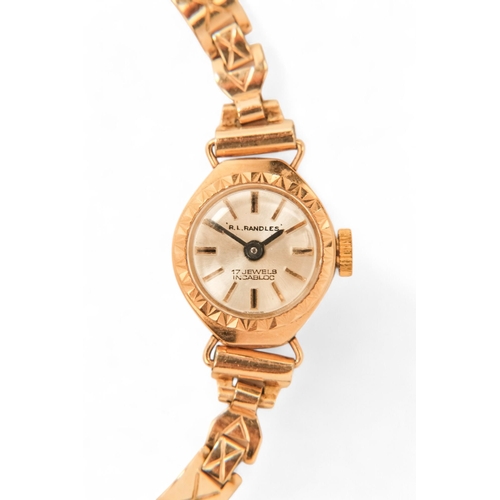 704 - A ladies 9ct gold cocktail watch - oval with a cream dial set out in baton numerals, 10.2g all in, t... 