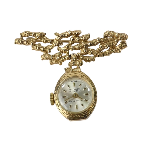 705 - A 9ct ladies fob watch - suspended from a bark effect bar, the silvered dial set out with baton nume... 