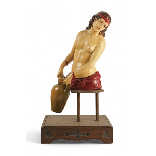 78 - An 'Old Charm Furniture' point of sale figure - modelled as a water-carrier, on a square oak base, 2... 