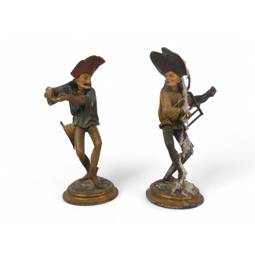 8 - A pair of late 19th century continental spelter candlesticks - modelled as grotesque jesters, 28cm h... 