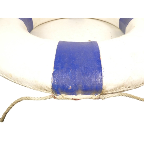 82 - A vintage Perry lifebuoy - canvas covered cork, painted white and blue with a rope band, 76cm diamet... 