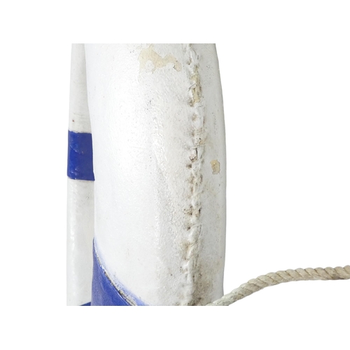 82 - A vintage Perry lifebuoy - canvas covered cork, painted white and blue with a rope band, 76cm diamet... 