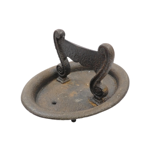 89 - A 19th century cast iron boot scraper - oval, the blade with scrolled supports, 31cm wide, together ... 