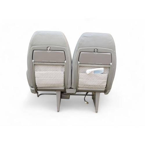 901 - A Siamese pair of aircraft seats from Concorde - in grey Connolly leather and cloth, with tilting ba... 