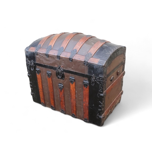 902 - A late 19th century domed trunk - tin on a wooden frame and lathes with steel brackets, 90 x 54 x 79... 