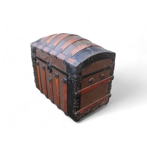 902 - A late 19th century domed trunk - tin on a wooden frame and lathes with steel brackets, 90 x 54 x 79... 