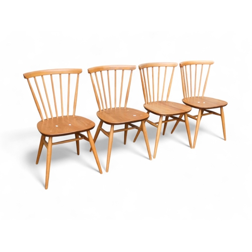 911 - A set of four Ercol beech and elm dining chairs - model 391 with spindle rail back and legs joined b... 