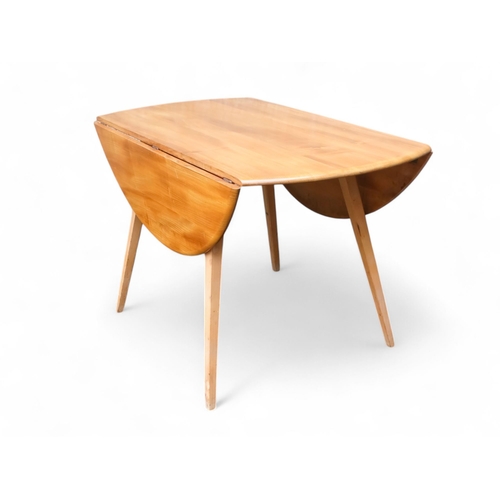 916 - An Ercol Windsor elm and beech drop leaf table - model 384, the oval top on splayed tapered square l... 