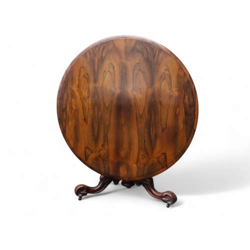 917 - A William IV rosewood loo table - the moulded circular top with a pendant frieze above a turned and ... 