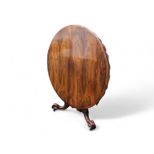 917 - A William IV rosewood loo table - the moulded circular top with a pendant frieze above a turned and ... 