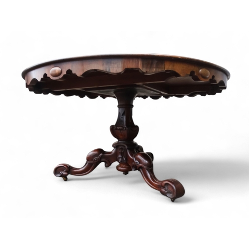 917 - A William IV rosewood loo table - the moulded circular top with a pendant frieze above a turned and ... 