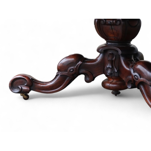 917 - A William IV rosewood loo table - the moulded circular top with a pendant frieze above a turned and ... 