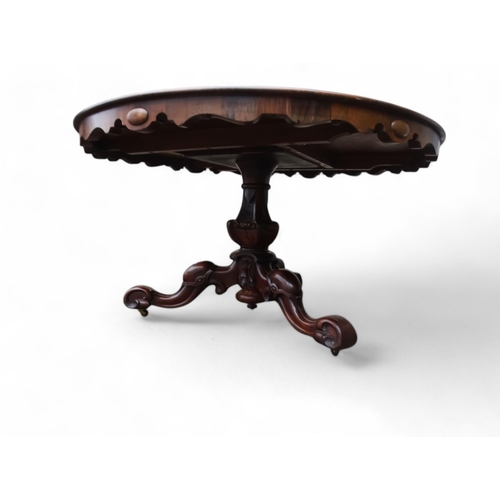 917 - A William IV rosewood loo table - the moulded circular top with a pendant frieze above a turned and ... 