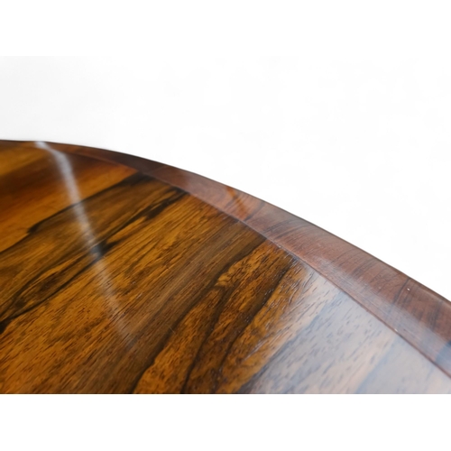 917 - A William IV rosewood loo table - the moulded circular top with a pendant frieze above a turned and ... 