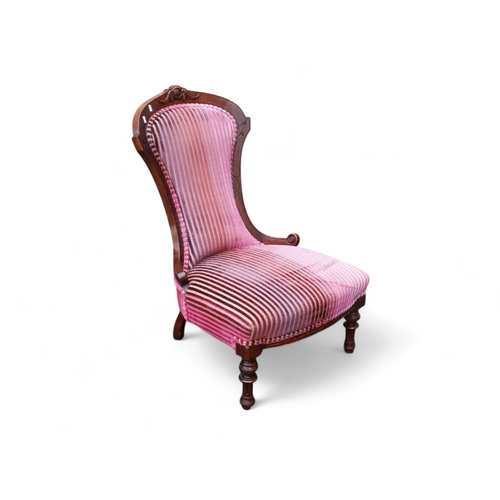 918 - A Victorian walnut low seat spoon back chair - upholstered in striped velvet, on turned legs.