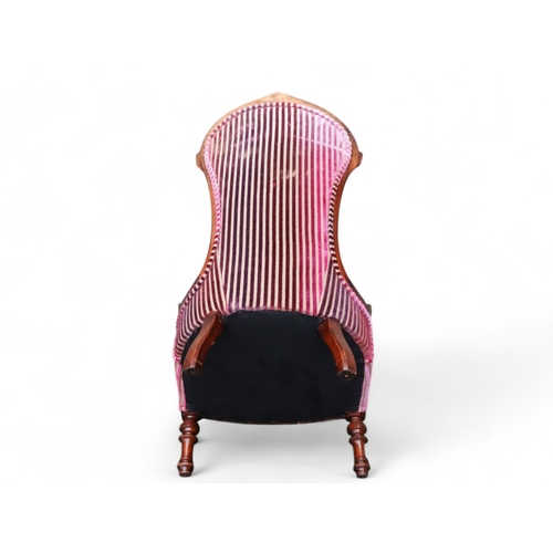 918 - A Victorian walnut low seat spoon back chair - upholstered in striped velvet, on turned legs.