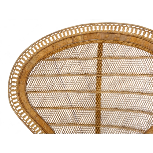 919 - A 1960s bamboo and rattan peacock chair with arched back - with a guilloche border, woven back panel... 