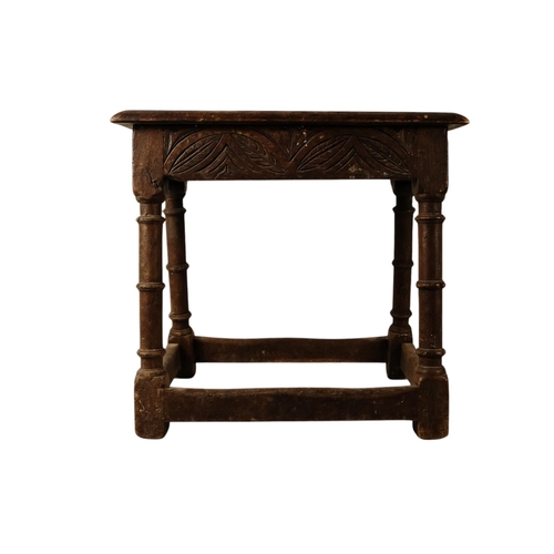 922 - A 17th century and later oak joint stool - the moulded rectangular seat above guilloche carved friez... 