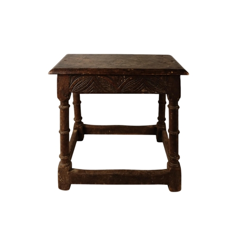 922 - A 17th century and later oak joint stool - the moulded rectangular seat above guilloche carved friez... 