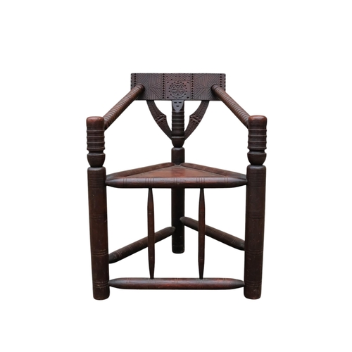 928 - A 17th century style oak turners chair - with chip carved rectangular back above a solid triangular ... 