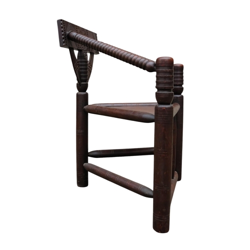 928 - A 17th century style oak turners chair - with chip carved rectangular back above a solid triangular ... 