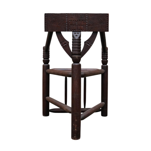 928 - A 17th century style oak turners chair - with chip carved rectangular back above a solid triangular ... 