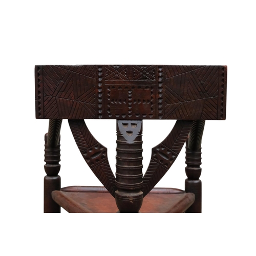 928 - A 17th century style oak turners chair - with chip carved rectangular back above a solid triangular ... 