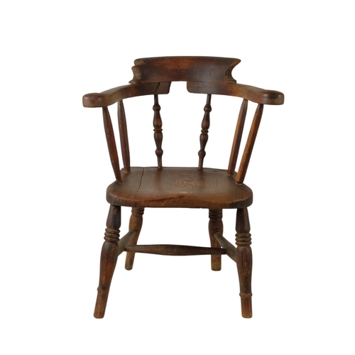 929 - A late 19th century beech and elm miniature captains chair - with a solid contoured seat stamped AG ... 