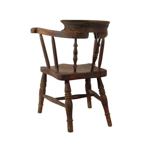 929 - A late 19th century beech and elm miniature captains chair - with a solid contoured seat stamped AG ... 