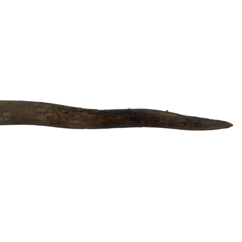 93 - A 19th century Indonesian kris - with wavy edged blade, carved handle with white metal mounts and a ... 