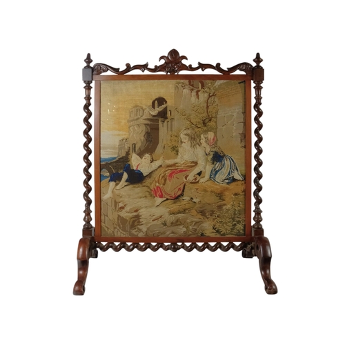 931 - A Victorian walnut fire screen - incorporating a Berlin work panel depicting children among castle r... 