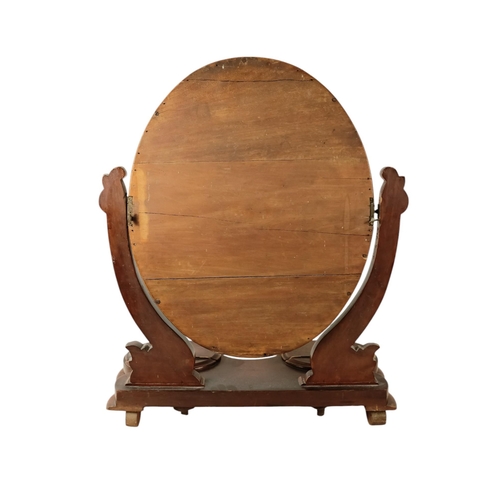 933 - A Victorian mahogany toilet mirror - the oval plate between curved supports, the base incorporating ... 