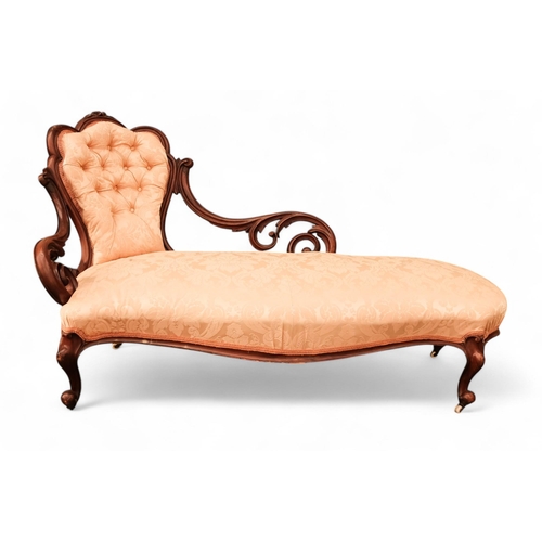 937 - A Victorian walnut and upholstered chaise longue - the button upholstered back with pierced foliate ... 