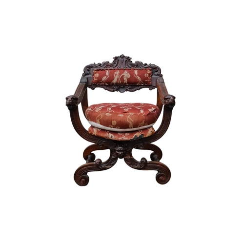 942 - A 17th century style continental walnut Savonarola chair - with carved lion mask finials.