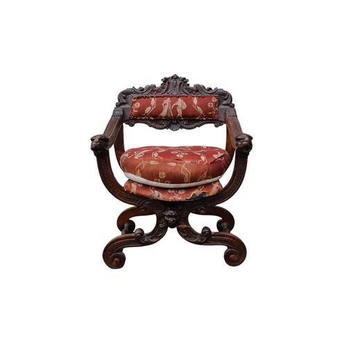 942 - A 17th century style continental walnut Savonarola chair - with carved lion mask finials.